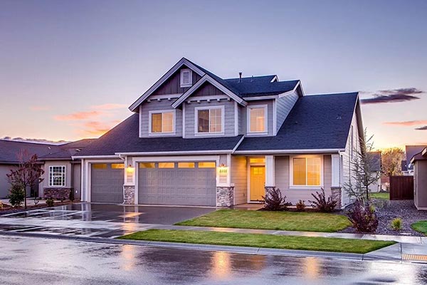 blue single-family home with two-car garage